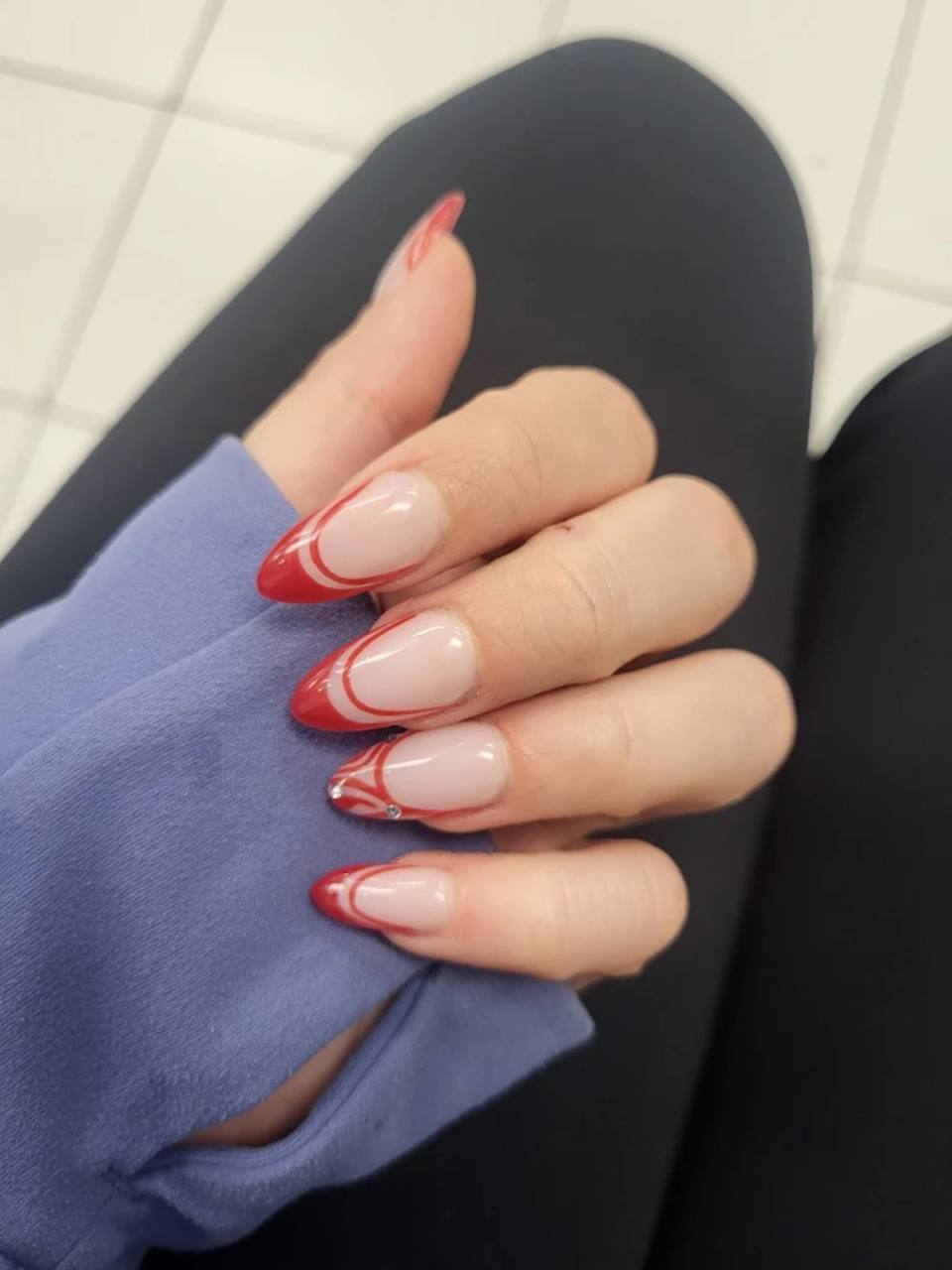 Red swirl French nail design.