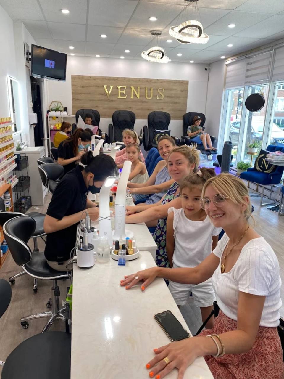 Clients enjoying manicure services inside Ongles Venus.